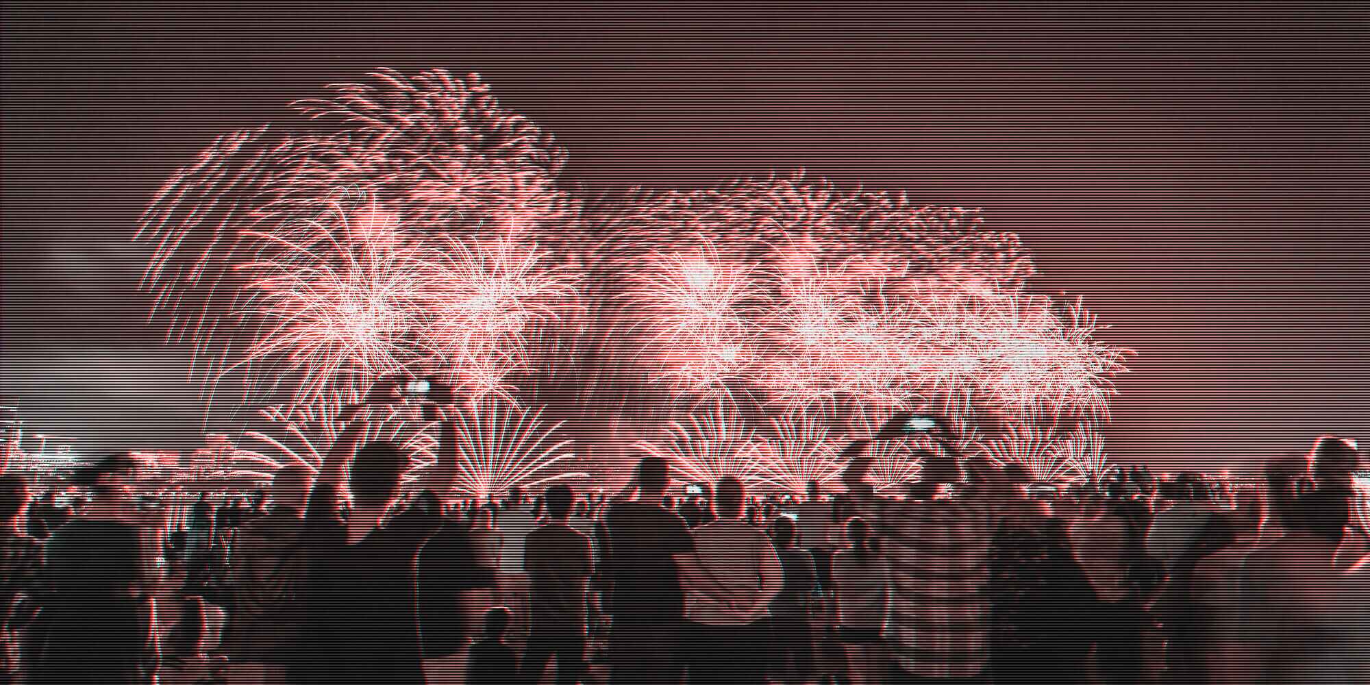people enjoying a fireworks display while some of them record it on their devices swearing that they'll actually watch it again sometime and re-live the experience when they're not living the experience while it's happening